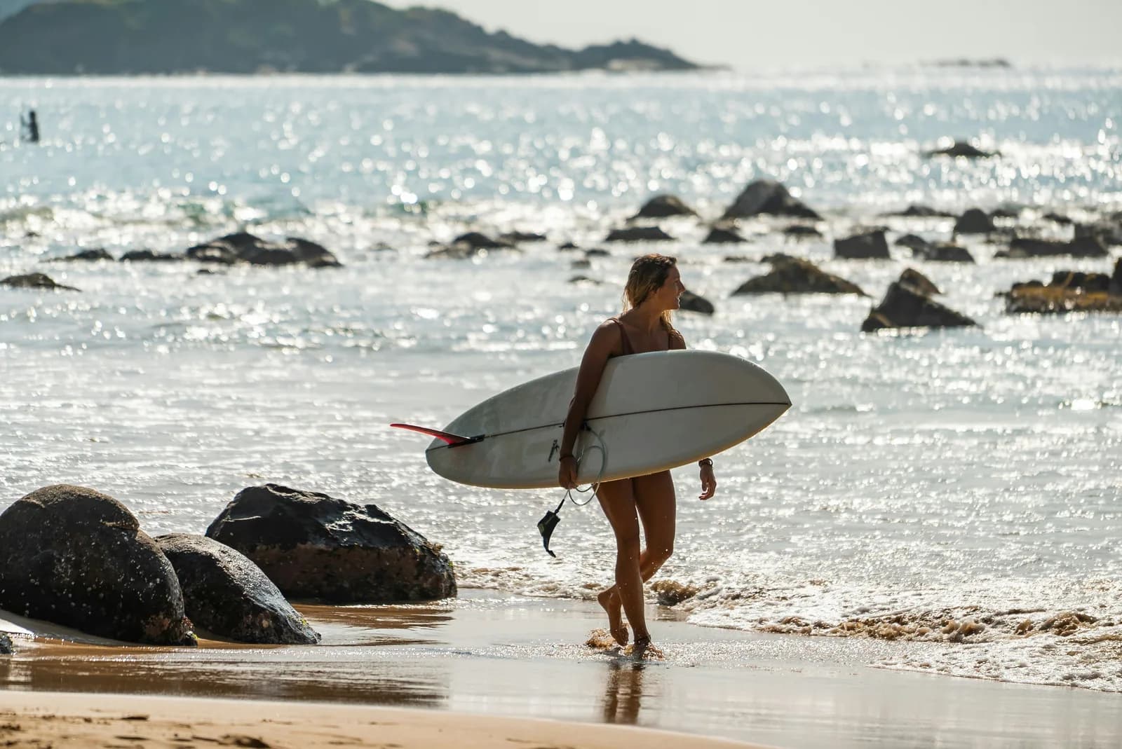 Surfer catching tropical ocean waves along Sri Lanka coast.